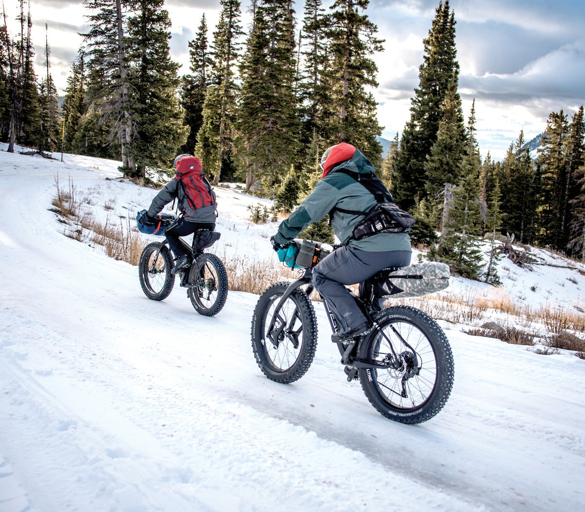 Wigwam sock wearers mountain biking on snowy terrain